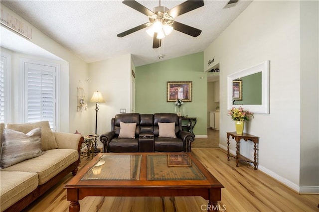 18993 Janisse Ln, Lake Elsinore, CA 92530 - living area with vaulted ceiling, light wood-type flooring, a ceiling fan, baseboards, and a textured ceiling