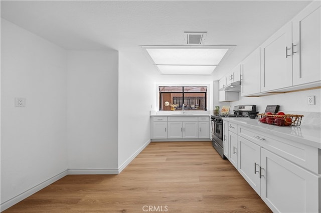 105 S Marguerita Ave Unit A, Alhambra, CA 91801 - kitchen featuring stainless steel gas range oven, under cabinet range hood, white cabinets, and light countertops