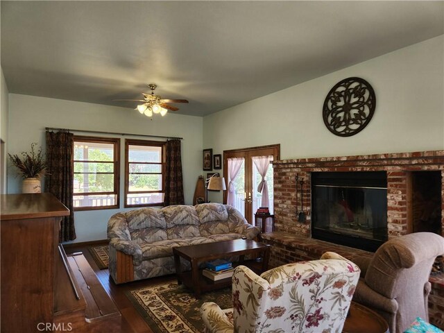 1014 Dusty Rd, Frazier Park, CA 93225 - living room featuring healthy amount of natural light, ceiling fan, dark wood-style floors, and a brick fireplace