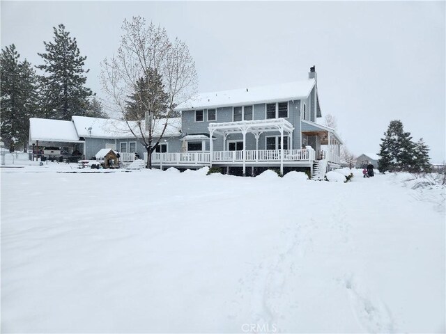 1014 Dusty Rd, Frazier Park, CA 93225 - snow covered rear of property with a deck and a chimney