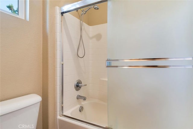 26392 Fowler Dr, Loma Linda, CA 92354 - bathroom featuring toilet and shower / bath combination with glass door