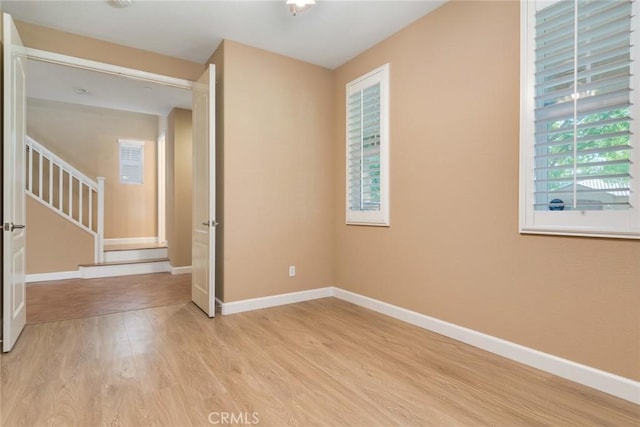 26392 Fowler Dr, Loma Linda, CA 92354 - unfurnished room featuring light wood-type flooring, baseboards, and stairs