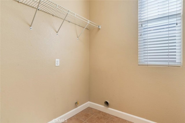 26392 Fowler Dr, Loma Linda, CA 92354 - washroom with baseboards and light tile patterned floors