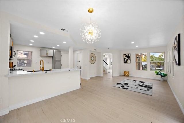 2407 Galisteo St, Corona, CA 92882 - unfurnished living room with healthy amount of natural light, baseboards, light wood finished floors, stairs, and recessed lighting