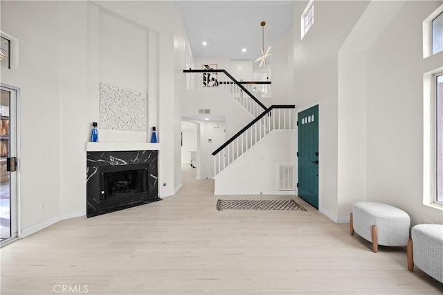 2407 Galisteo St, Corona, CA 92882 - entryway with a high ceiling, wood finished floors, stairs, healthy amount of natural light, and a high end fireplace