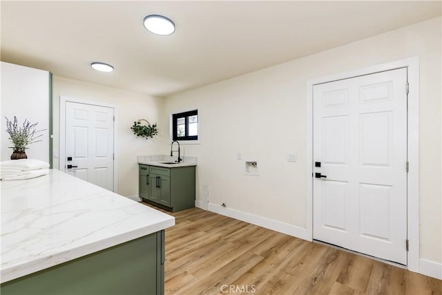 1216 W River Ln, Santa Ana, CA 92706 - laundry area with hookup for a washing machine, light wood-style flooring, baseboards, and cabinet space