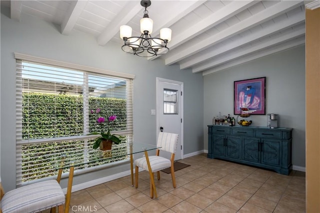 sitting room with a chandelier, light tile patterned flooring, and baseboards