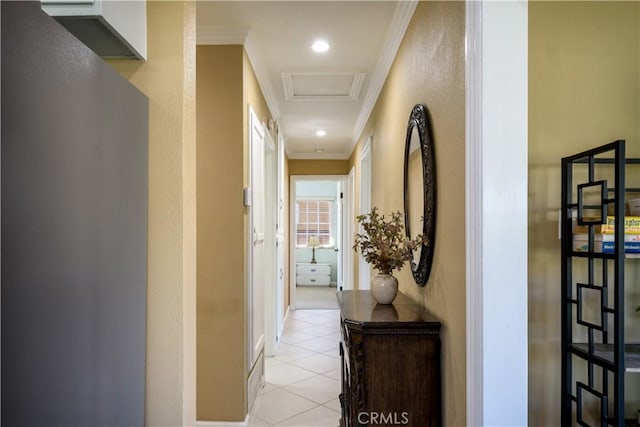 corridor with ornamental molding, light tile patterned floors, and attic access