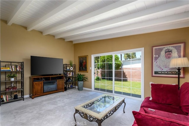 carpeted living area featuring beam ceiling and baseboards