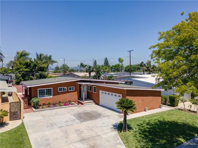 view of front facade featuring driveway, stucco siding, and an attached garage