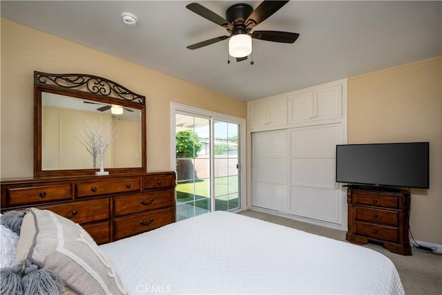 carpeted bedroom with access to outside and a ceiling fan