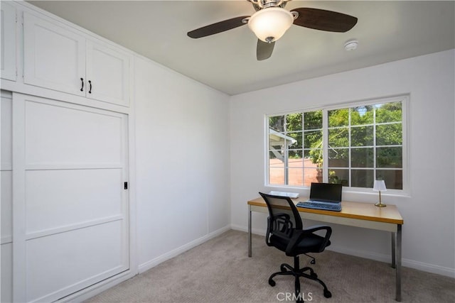 office area with light carpet, baseboards, and ceiling fan