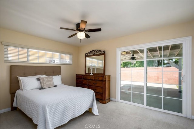 bedroom featuring access to outside, baseboards, light colored carpet, and ceiling fan