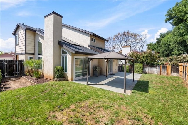 13607 Chaparral Trl, Yucaipa, CA 92399 - back of house featuring a chimney, a patio, a gazebo, and stucco siding