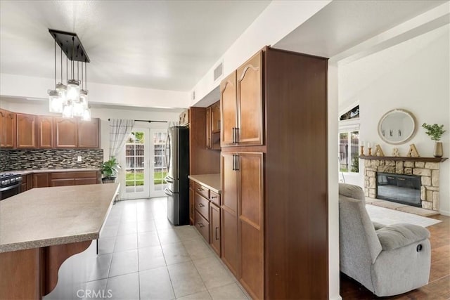 13607 Chaparral Trl, Yucaipa, CA 92399 - kitchen with french doors, healthy amount of natural light, freestanding refrigerator, and backsplash