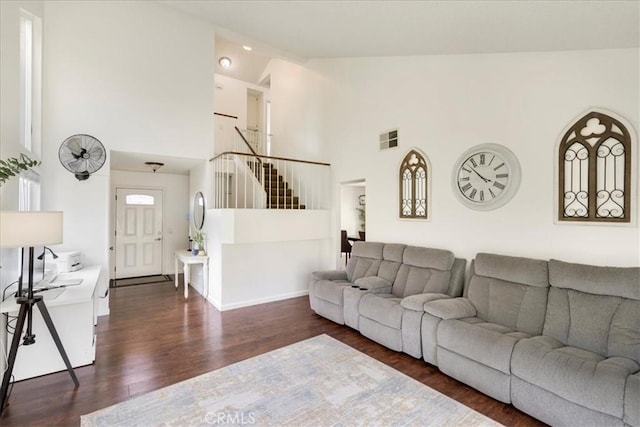 13607 Chaparral Trl, Yucaipa, CA 92399 - living room with high vaulted ceiling, dark wood-style floors, and stairs