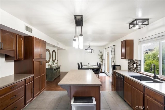 13607 Chaparral Trl, Yucaipa, CA 92399 - kitchen with a sink, dishwasher, a kitchen island, backsplash, and hanging light fixtures