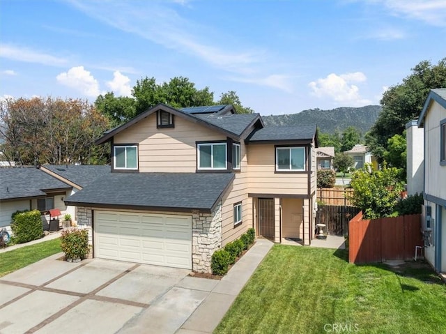 13607 Chaparral Trl, Yucaipa, CA 92399 - view of front of property with roof with shingles, roof mounted solar panels, driveway, an attached garage, and stone siding