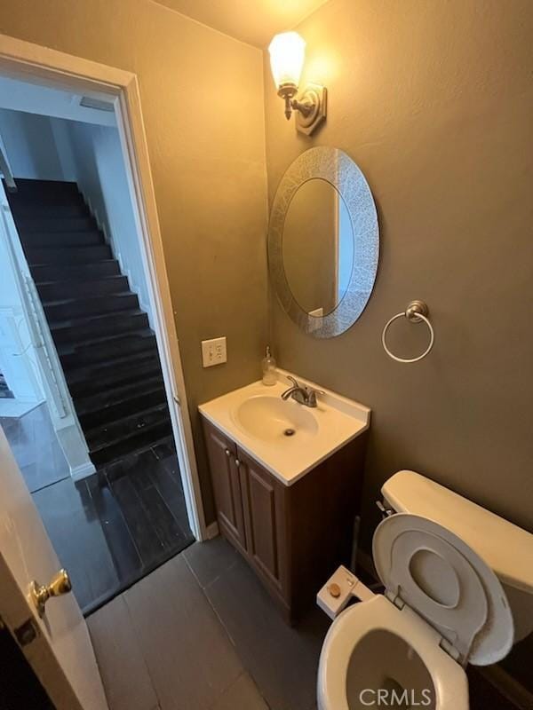 half bathroom with toilet and vanity