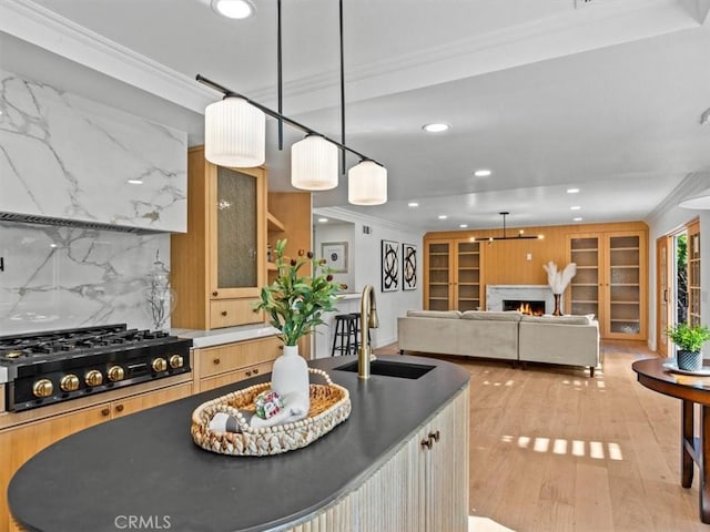 5505 Paseo Joaquin, Yorba Linda, CA 92886 - kitchen with black gas cooktop, crown molding, recessed lighting, a lit fireplace, and light wood-style floors