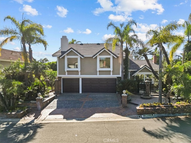 5505 Paseo Joaquin, Yorba Linda, CA 92886 - view of front facade with stucco siding, a garage, decorative driveway, and a chimney