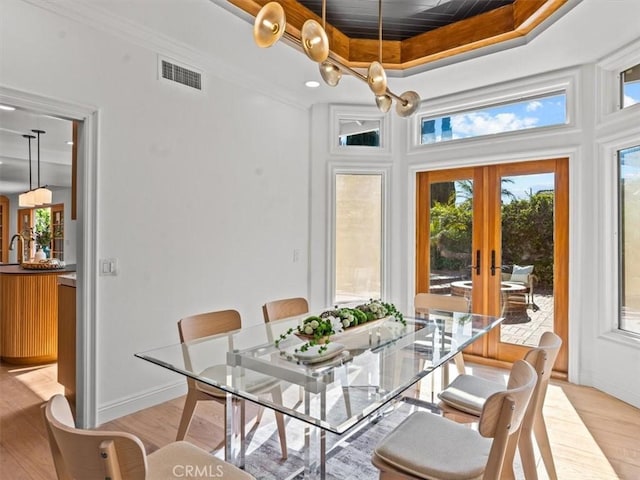 5505 Paseo Joaquin, Yorba Linda, CA 92886 - dining area featuring light wood-style flooring, a tray ceiling, plenty of natural light, french doors, and ornamental molding