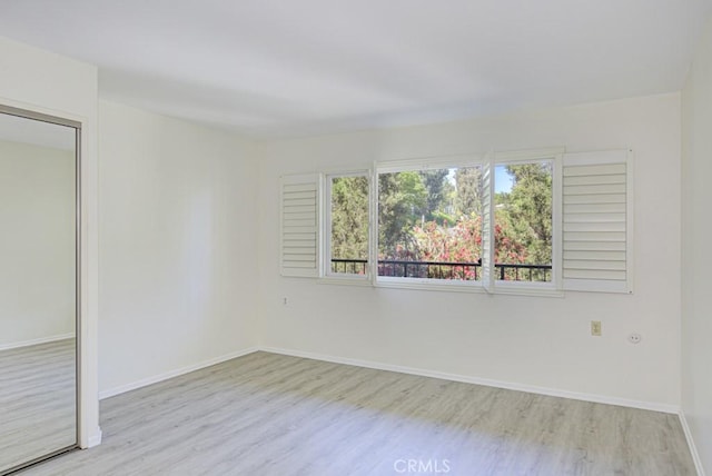 3336 Punta Alta Unit 2F, Laguna Woods, CA 92637 - unfurnished room with wood finished floors and baseboards