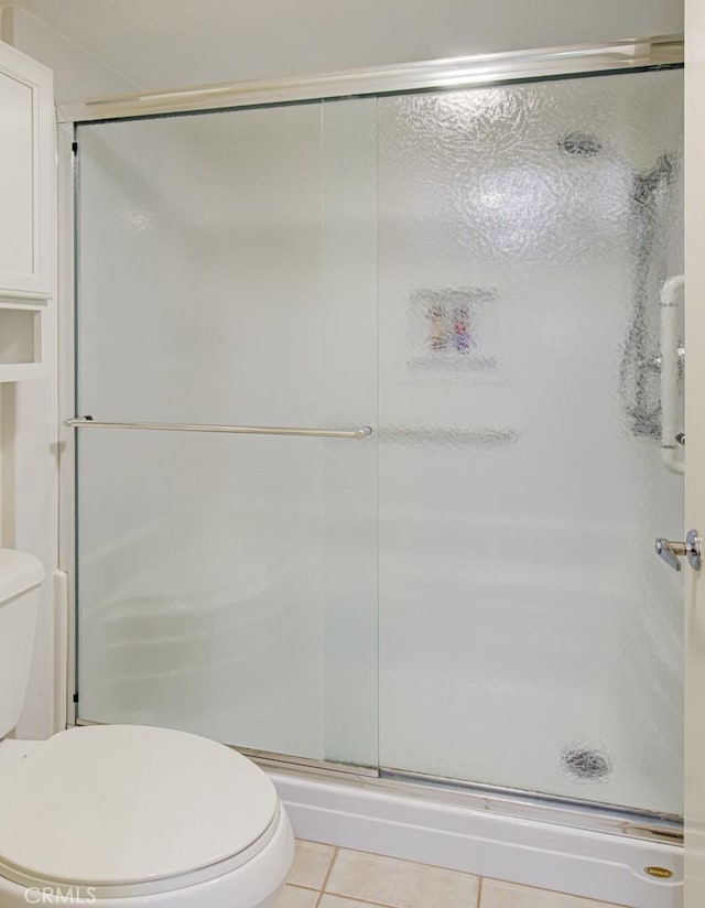 3336 Punta Alta Unit 2F, Laguna Woods, CA 92637 - full bath featuring a stall shower, tile patterned flooring, and toilet