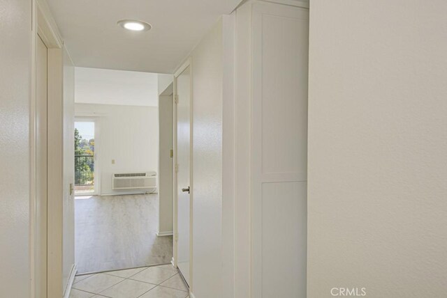 3336 Punta Alta Unit 2F, Laguna Woods, CA 92637 - hallway with light tile patterned floors, a wall mounted AC, and baseboards