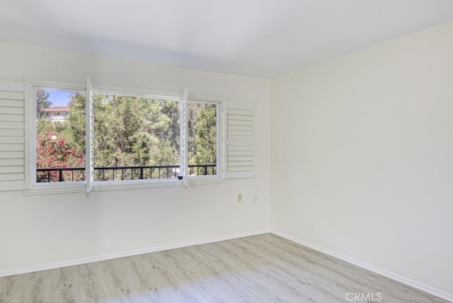3336 Punta Alta Unit 2F, Laguna Woods, CA 92637 - unfurnished room with wood finished floors and baseboards