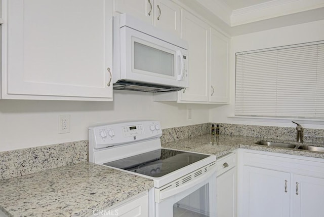 3336 Punta Alta Unit 2F, Laguna Woods, CA 92637 - kitchen with white appliances, white cabinets, a sink, and crown molding