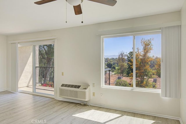 3336 Punta Alta Unit 2F, Laguna Woods, CA 92637 - empty room with ceiling fan, wood finished floors, a wall mounted AC, and baseboards