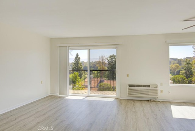3336 Punta Alta Unit 2F, Laguna Woods, CA 92637 - empty room featuring wood finished floors, an AC wall unit, and baseboards