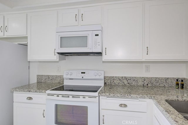 3336 Punta Alta Unit 2F, Laguna Woods, CA 92637 - kitchen with white appliances, white cabinets, light stone countertops, and a sink