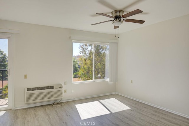 3336 Punta Alta Unit 2F, Laguna Woods, CA 92637 - spare room with wood finished floors, a wall unit AC, and healthy amount of natural light