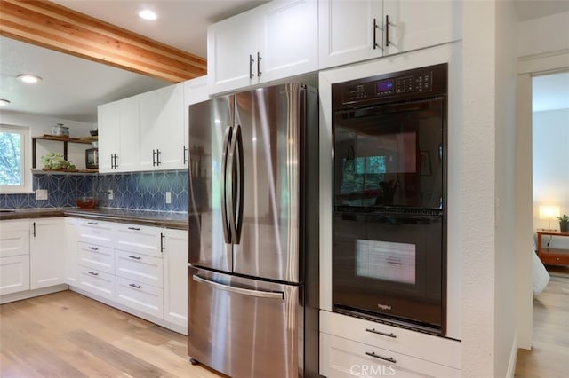 5192 Oak Rd, Mariposa, CA 95345 - kitchen featuring freestanding refrigerator, light wood finished floors, beam ceiling, dark countertops, and decorative backsplash