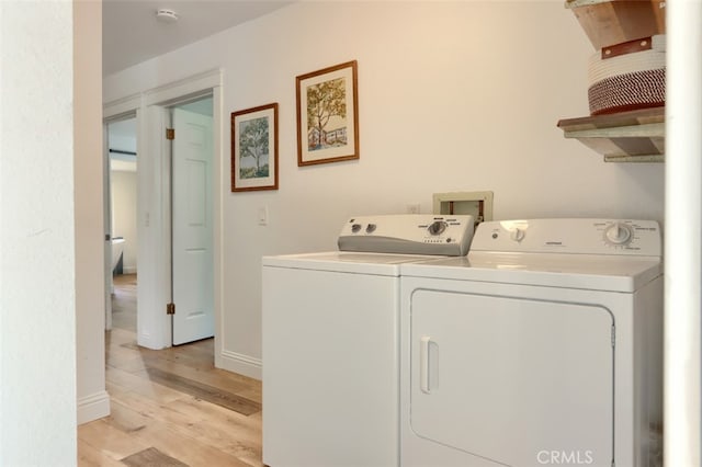 5192 Oak Rd, Mariposa, CA 95345 - washroom featuring washer and clothes dryer, light wood-style floors, and baseboards