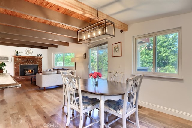 5192 Oak Rd, Mariposa, CA 95345 - dining area with beamed ceiling, light wood finished floors, a brick fireplace, and baseboards