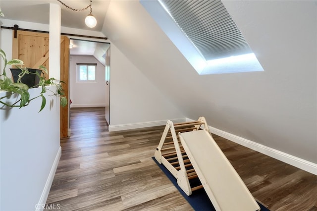 5192 Oak Rd, Mariposa, CA 95345 - hall with baseboards, vaulted ceiling, wood finished floors, and a skylight
