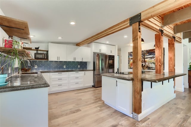 5192 Oak Rd, Mariposa, CA 95345 - kitchen with freestanding refrigerator, open shelves, light wood-style floors, black microwave, and white cabinets