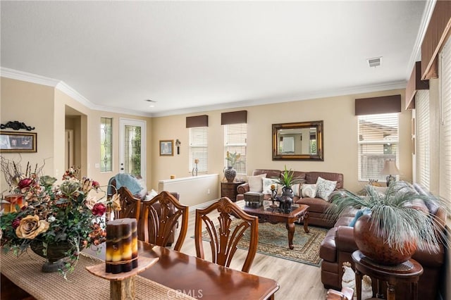 23725 Scarlet Oak Dr, Murrieta, CA 92562 - dining area with healthy amount of natural light, light wood-style flooring, and crown molding