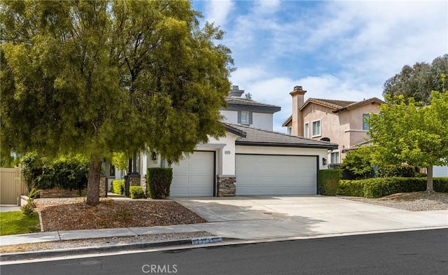 23725 Scarlet Oak Dr, Murrieta, CA 92562 - view of property hidden behind natural elements featuring concrete driveway, an attached garage, stucco siding, a tiled roof, and stone siding