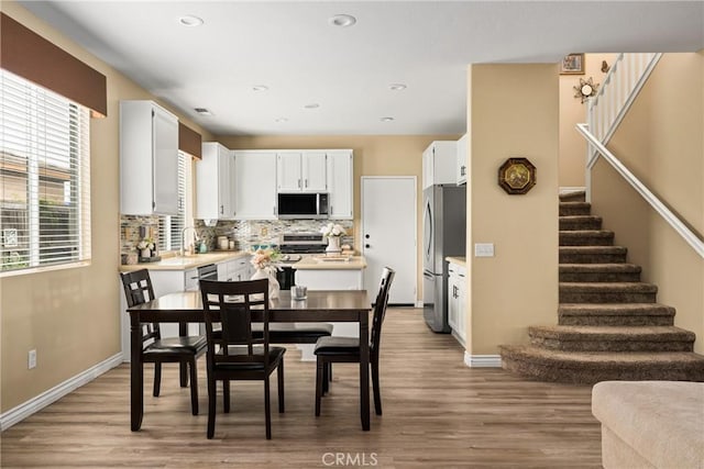 23725 Scarlet Oak Dr, Murrieta, CA 92562 - dining room with stairway, light wood finished floors, baseboards, and recessed lighting