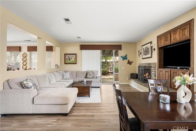 23725 Scarlet Oak Dr, Murrieta, CA 92562 - living area featuring light wood-type flooring, a brick fireplace, and baseboards