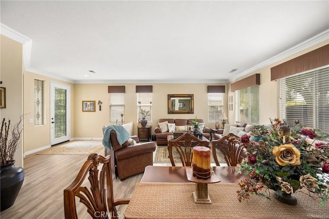 23725 Scarlet Oak Dr, Murrieta, CA 92562 - dining room featuring healthy amount of natural light, light wood-style floors, crown molding, and baseboards