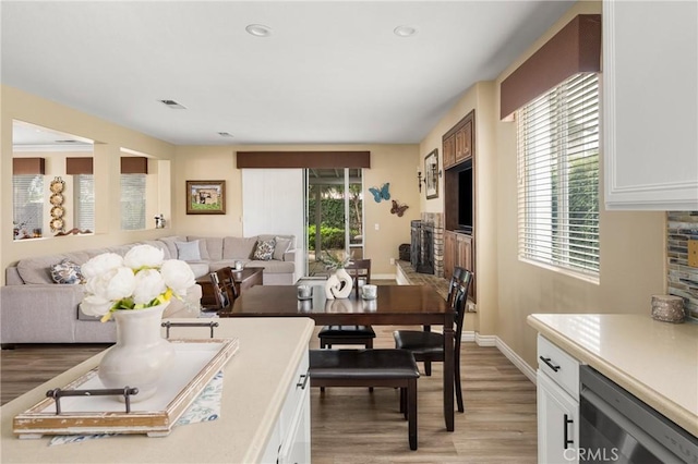 23725 Scarlet Oak Dr, Murrieta, CA 92562 - dining room featuring light wood-style floors, baseboards, recessed lighting, and a fireplace
