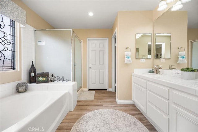 23725 Scarlet Oak Dr, Murrieta, CA 92562 - full bath featuring a bath, a stall shower, wood finished floors, and recessed lighting