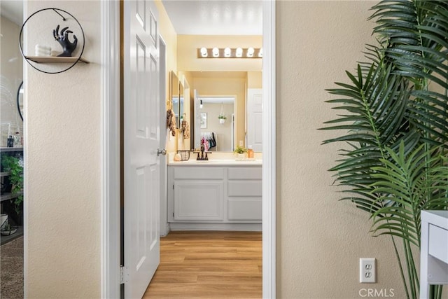 23725 Scarlet Oak Dr, Murrieta, CA 92562 - bathroom featuring a textured wall, wood finished floors, and vanity