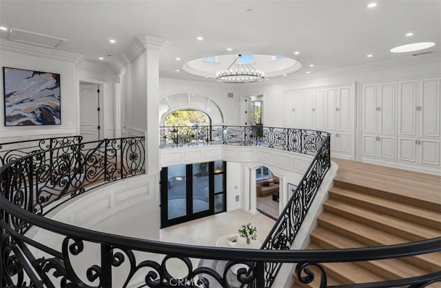 71 Ritz Cove Dr, Dana Point, CA 92629 - staircase featuring french doors, crown molding, recessed lighting, and a decorative wall