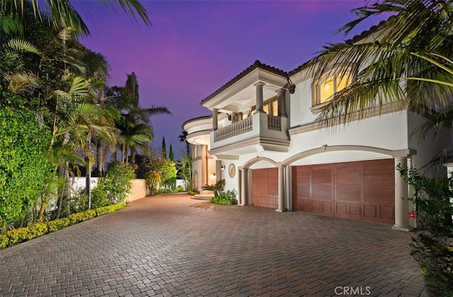 71 Ritz Cove Dr, Dana Point, CA 92629 - mediterranean / spanish house with a balcony, a garage, decorative driveway, and stucco siding
